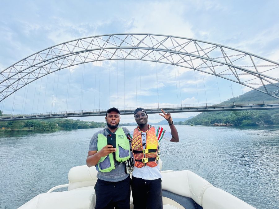 Guests on a Volta Lake boat cruise beneath the Adomi Bridge, Akosombo