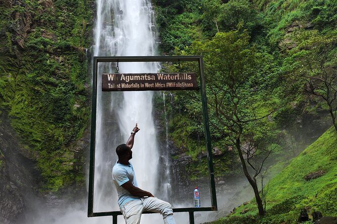 Guest at the Wli Agumatsa Waterfalls sign